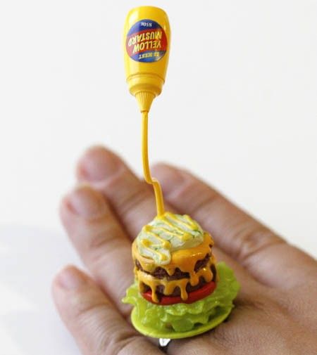 A super cute plate with a double cheesehamburger on it with the mustard being pour into it!! Yummy!!! Yummy!!! It measures approx. 1 inch wide and 3 inch high is on a silver plated adjustable bang that will fit most ring sizes.: 