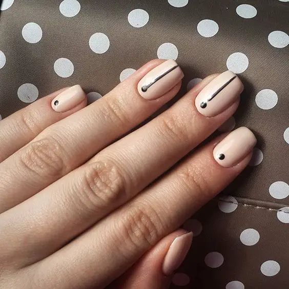 Try these easy-to-master minimal nail art designs from @Stylecaster | nude with black stripes and dots: 
