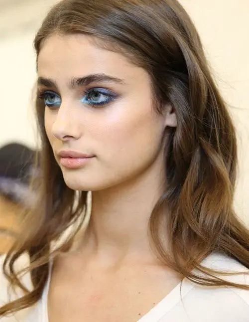 Bold eyebrows, bright-blue eye makeup, and lightly tousled hair: 