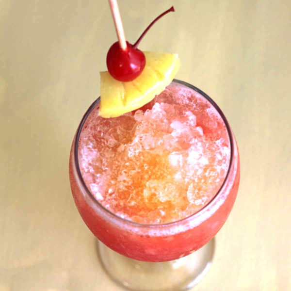 The Kiss on the Lips drink recipe is based on a drink served on Carnival Cruise Lines. It's pure, simple deliciousness, mixing the fruity flavors of peach, mango and berry. Great to serve at parties.
