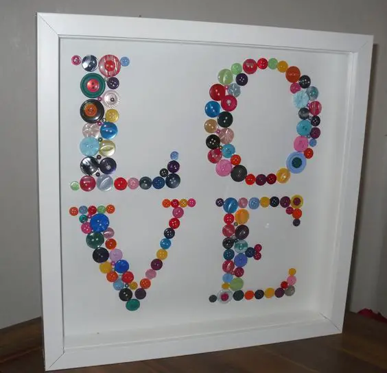 Stunning 'LOVE' button artwork made with a selection of multi-coloured buttons of all shapes and sizes, individually glued in place and displayed in a beautiful deep box frame. Could do this for "WILL" to put in his room!