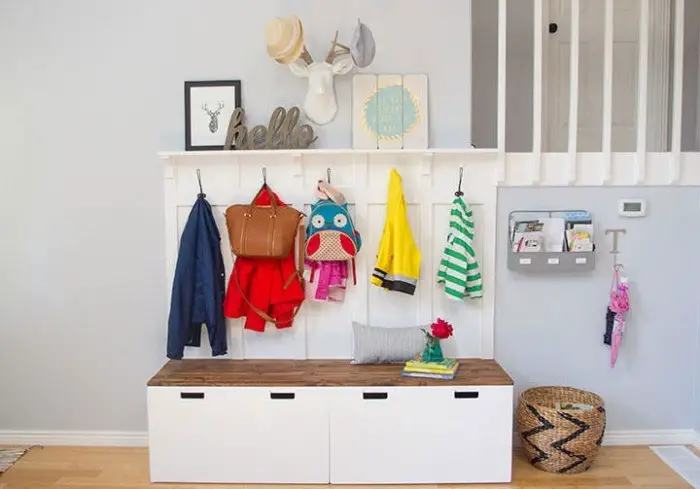 A simple tent, coat hanger and shelves are a great example of proper use of space in a small hallway. 