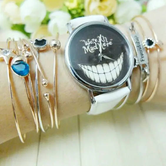WERE ALL MAD HERE WATCH WHITE FAUX LEATHER BAND STAINLESS STEEL BACK. CUTE ALICE IN WONDERLAND WATCH WITH THE CHESIRE CAT GRIN. AWESOME CONVERSATION PIECE. Fashion Accessories Watches: 
